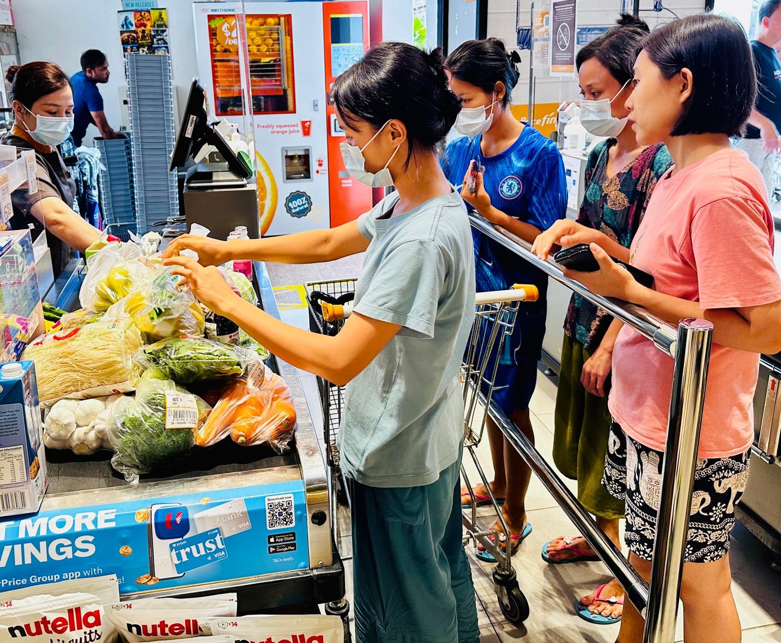 New Days helper assisting with grocery shopping