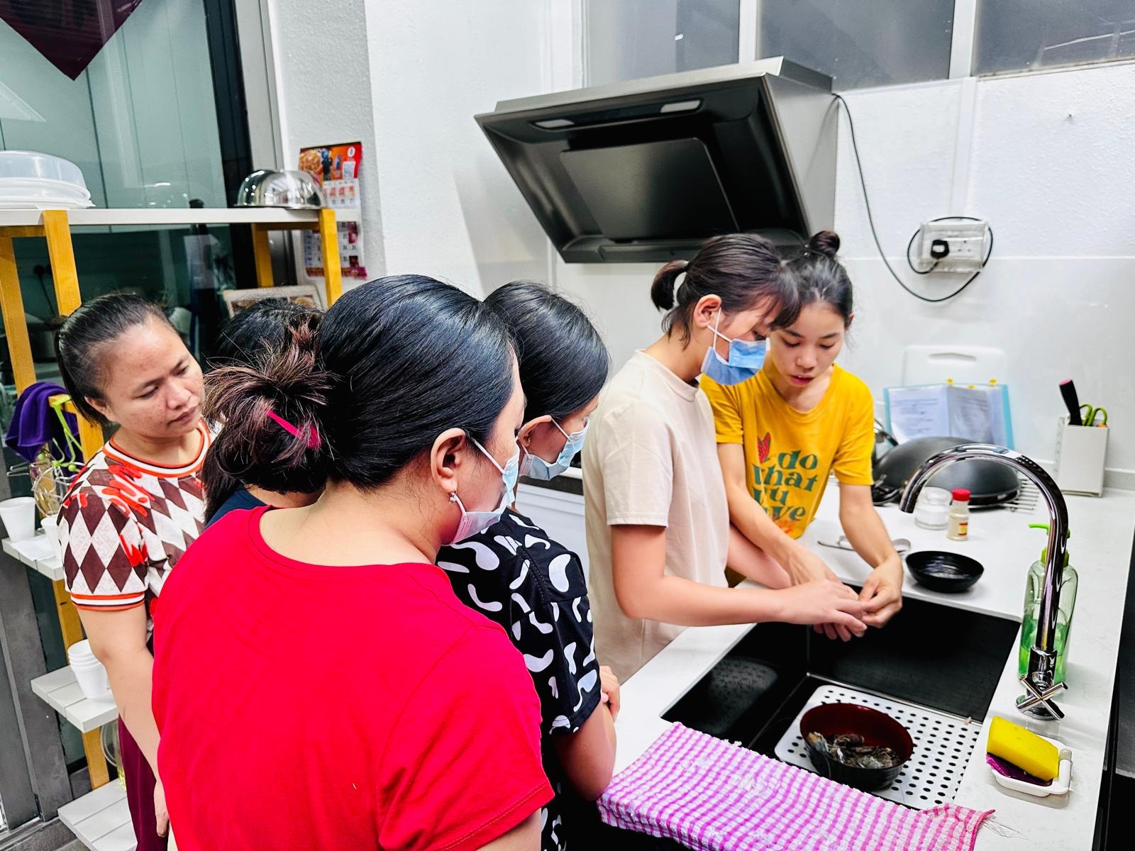 Group of New Days helpers in kitchen training session
